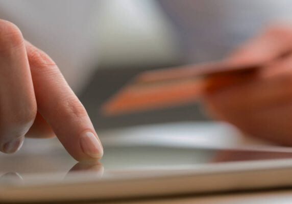 A customer paying online by card on a tablet
