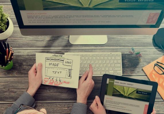 Planning a website: a hand-drawn wireframe next to a desktop and tablet showing the finished design